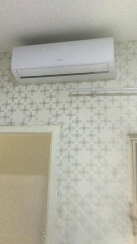 a bathroom with a white air vent on the ceiling at Locapart Hospedagens - Centro in Chapecó