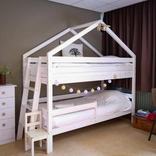 a white bunk bed with a ladder in a room at Het Huis van Bewustzijn in Limmen