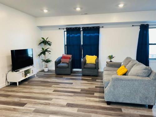a living room with two couches and a flat screen tv at Vacation Home in CLT King and 3Q in Charlotte