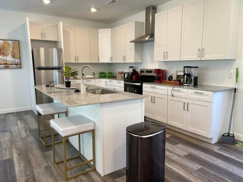 a kitchen with white cabinets and a sink and a counter at Vacation Home in CLT King and 3Q in Charlotte