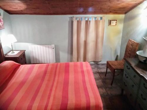 a bedroom with a bed and a dresser and a window at Casa Rural Casa Martin in Cueva de Ágreda