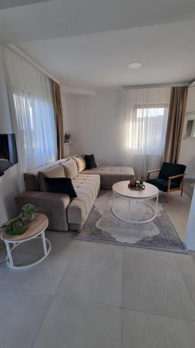 a living room with a couch and a table at Golija Simovic home in Radaljica
