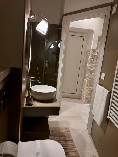 a bathroom with a white sink and a mirror at DIMORA BELLAVISTA in Bitonto