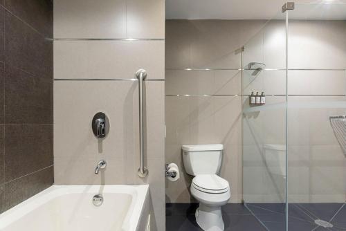 a bathroom with a toilet and a glass shower at Crowne Plaza Lima by IHG in Lima