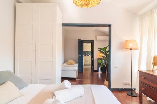 a bedroom with a bed and a room with a mirror at Riverfront studio in Lisbon