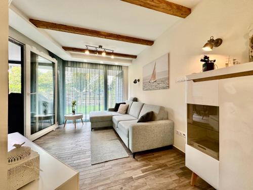 a living room with a couch and a fireplace at LAKE MOMENTS - Ruby Garden Apartment in Balatonszemes