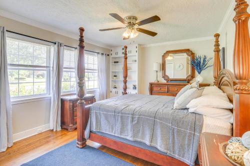 a bedroom with a bed and a ceiling fan at Inviting Jacksonville Home Less Than Half Mi to University in Jacksonville