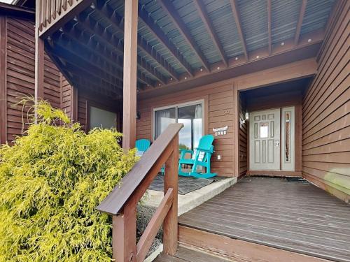 a porch of a house with blue chairs on it at Sunplace 30 in McHenry