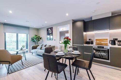 a kitchen and living room with a table and chairs at 2 Bedroom Apartment Leeds City Centre - Free Parking in Leeds