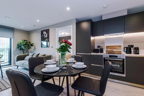 a kitchen and living room with a table and chairs at 2 Bedroom Apartment Leeds City Centre - Free Parking in Leeds