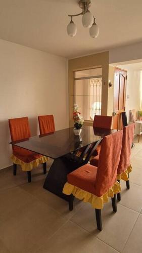 a dining room with a table and chairs at Apartamento duplex a 1 cuadra de Playa Naplo in Pucusana