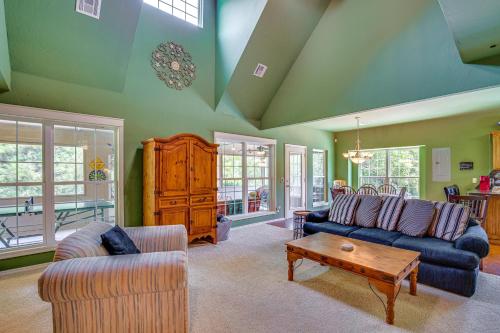 a living room with two couches and a coffee table at half Mi to Lake Texoma Home with Fire Pit and Grill! in Kingston