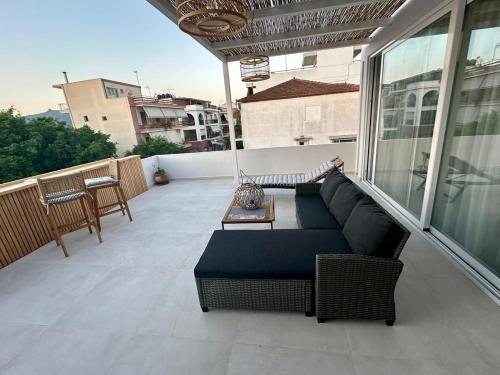 a balcony with a couch and a table at AMINA APARTMENTS in Zakynthos Town