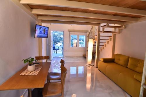 a living room with a couch and a table at Thea Suite & Loft in Kavala
