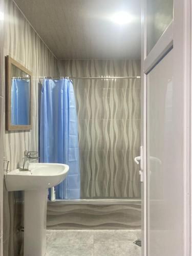 a bathroom with a sink and a shower at Panorama City Kutaisi in Kutaisi