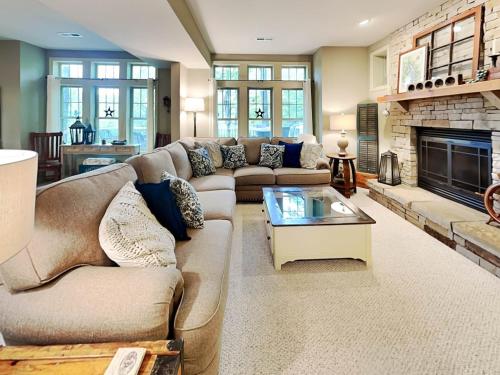 a living room with a couch and a fireplace at Acorn Cottage in Oakland