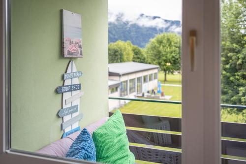 a room with a window with a view of a house at MOOKI Beach Apartment in Bodensdorf