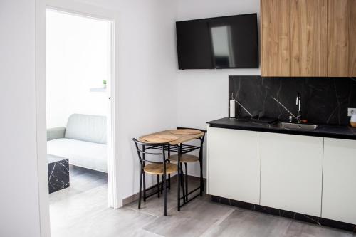 a kitchen with a sink and a counter with a stool at Gaviotas Beach Golf in Almerimar