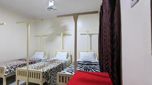 Кровать или кровати в номере JACARANDA HOMESTAY