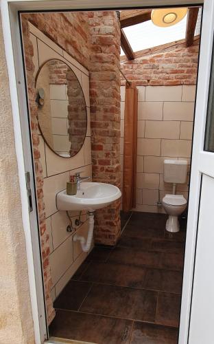 a bathroom with a sink and a toilet at übernachtung in unserem Wohnwagen in Gračac