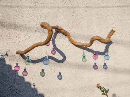 a group of christmas ornaments hanging on a wall at Filoxenia Pagonis in Vília