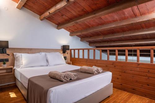 a bedroom with a bed with two towels on it at Ida Village in Hersonissos