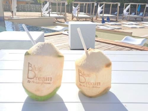 two slices of watermelons on a table near a pool at Blue dream Hamaca in Grand-Bourg