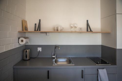 a kitchen with a sink and a counter top at Smiltynės Jachtklubas in Klaipėda
