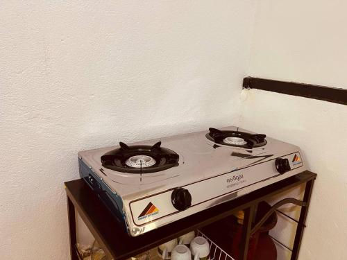 a stove top oven sitting on top of a table at Inap Desa R'Sawit Pintu A in Sekincan