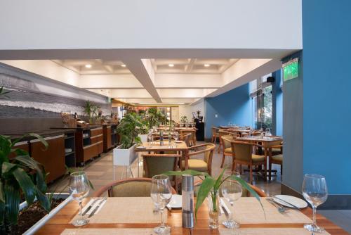 a restaurant with wooden tables and chairs and a dining room at Crowne Plaza Lima by IHG in Lima