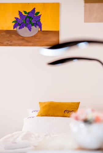 a bedroom with a bed with purple flowers on it at Orgona Vendégház Golop in Golop