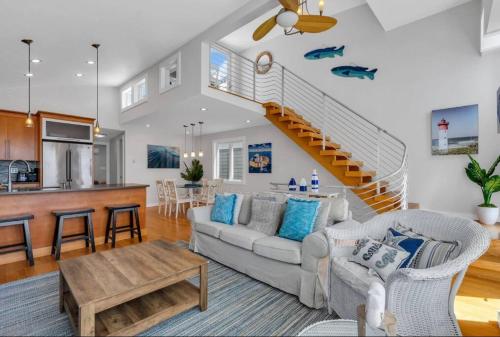 a living room with a couch and a staircase at Boardwalk Access, Ocean View in Point Pleasant Beach