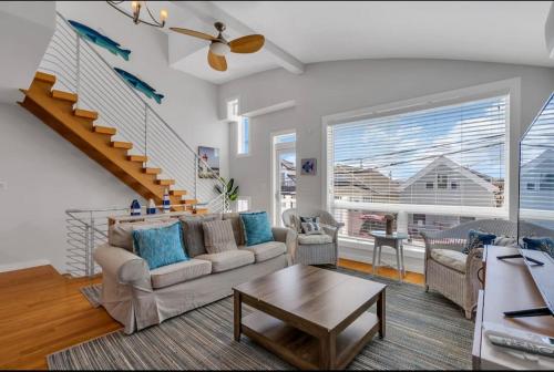 a living room with a couch and a table at Boardwalk Access, Ocean View in Point Pleasant Beach
