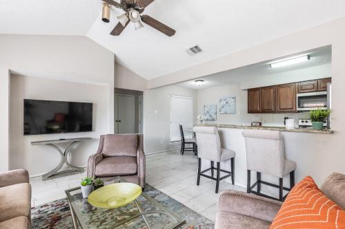 a living room with a bar and a kitchen at Frisco Elegance Retreat in Frisco