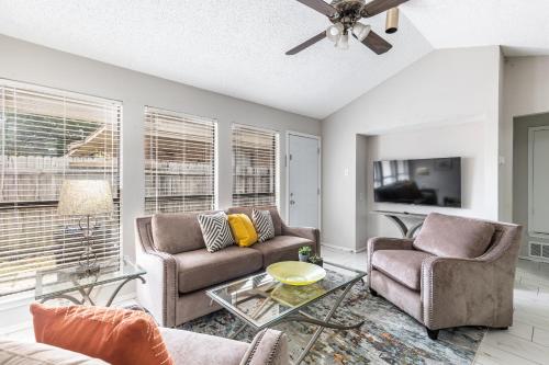 a living room with two couches and a tv at Frisco Elegance Retreat in Frisco