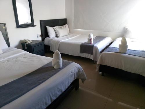 Postel nebo postele na pokoji v ubytování hotel laguna 24
