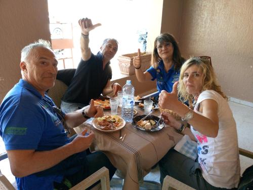 a group of people sitting around a table eating food at Dar alibaba in Douz