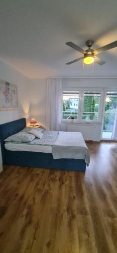 a bedroom with a bed and a ceiling fan at Dom Wczasowy Adela in Łeba