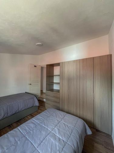 a bedroom with a bed and a closet at Casa palmera in San Baltasar