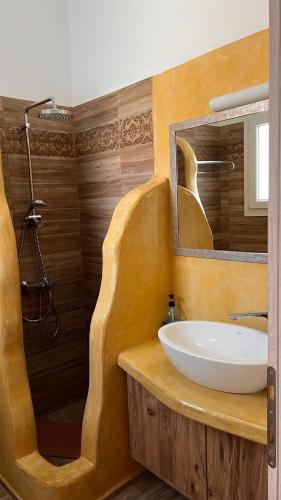 a bathroom with a sink and a shower at Lighthouse View Maisonette in Azolimnos Syros