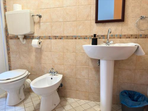 a bathroom with a toilet and a sink at Poseidon Bay Residence in Milazzo