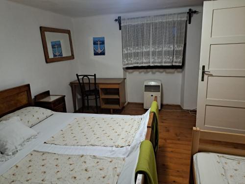 a bedroom with a bed and a window at Kuća za odmor Arija in Novi Vinodolski