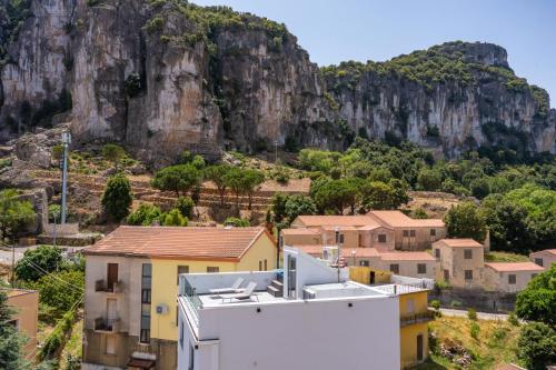 a view of a town with a mountain in the background at Barighouse in Ulassai