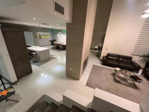 a living room with a couch and a table at Casa Concept Delicias in Delicias