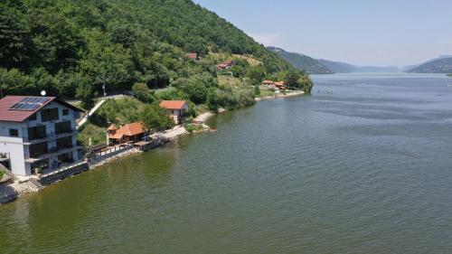 arial view of a river with a house on the shore at Dunavska Vila Milosavljevic in Donji Milanovac