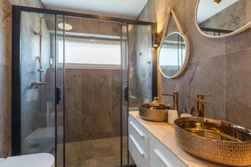 a bathroom with two sinks and a shower at Villa Maša in Rovinj