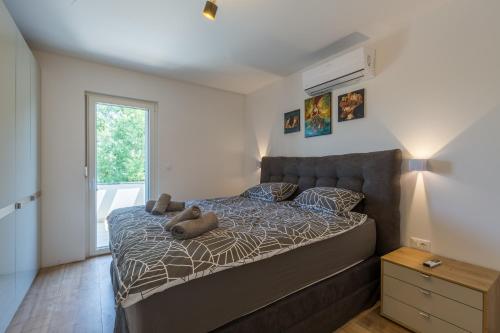 a bedroom with a bed with a teddy bear on it at Villa Maša in Rovinj