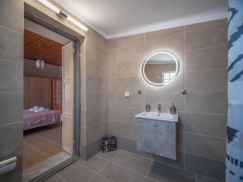 a bathroom with a sink and a mirror at Traditional Stone Villa 1 in Ellinikón