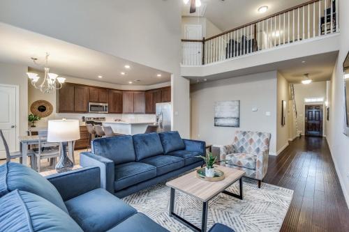 a living room with a blue couch and a table at Irving Bliss in Irving