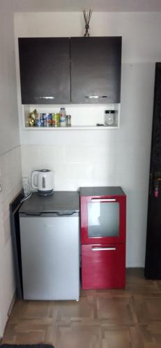 a small kitchen with a red and white refrigerator at Marko Apartments in Struga